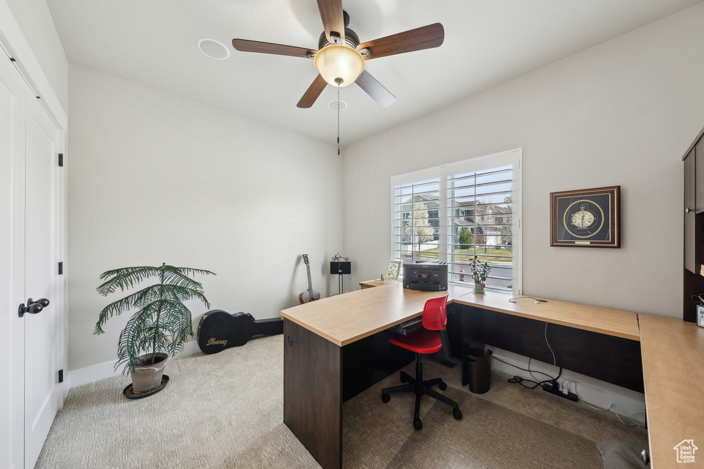 Home office featuring baseboards, a ceiling fan, and carpet floors