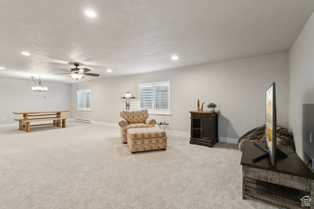Living area featuring recessed lighting, baseboards, light colored carpet, a ceiling fan, and baseboard heating