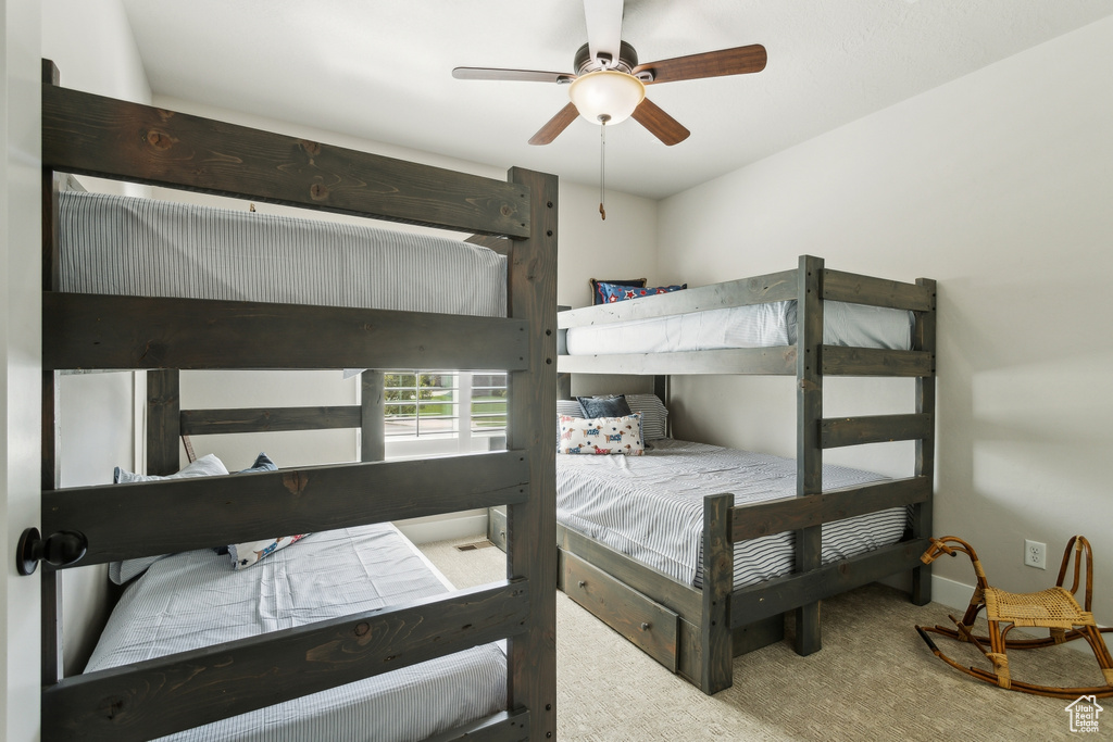 Carpeted bedroom with ceiling fan