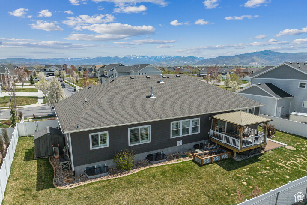 Exterior space featuring central AC unit, a mountain view, a residential view, and a fenced backyard