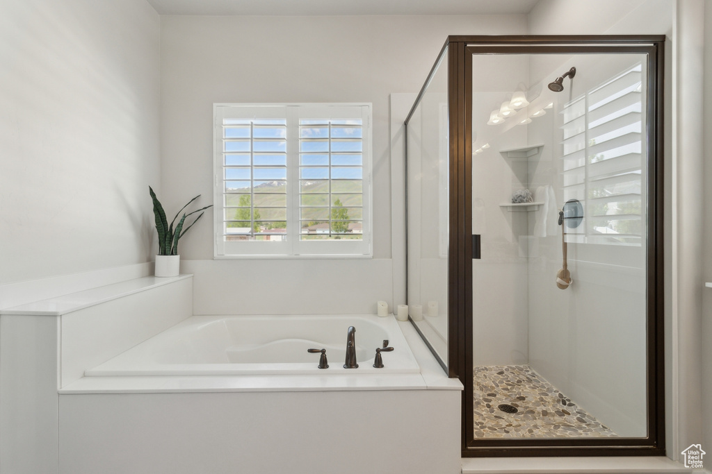 Full bathroom featuring a stall shower and a garden tub