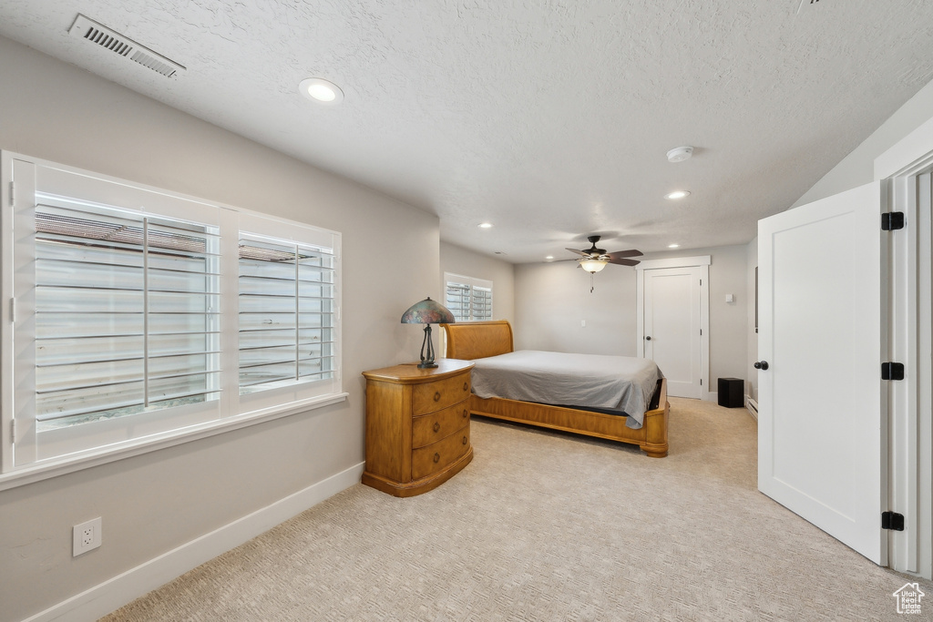 Bedroom featuring a textured ceiling, carpet flooring, visible vents, baseboards, and recessed lighting