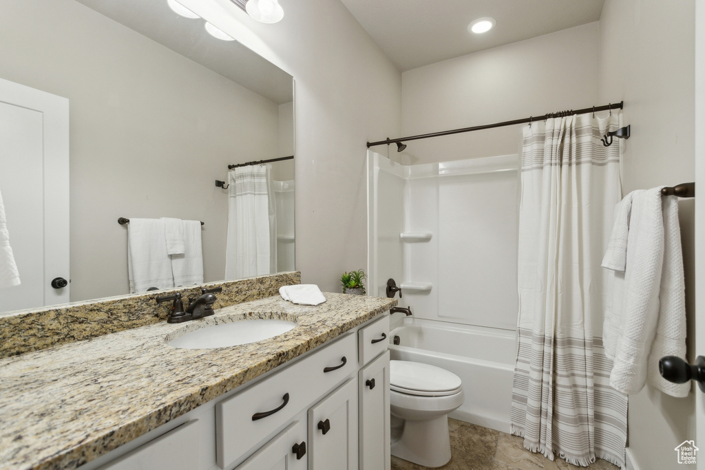 Bathroom with vanity, toilet, shower / bath combo with shower curtain, and recessed lighting