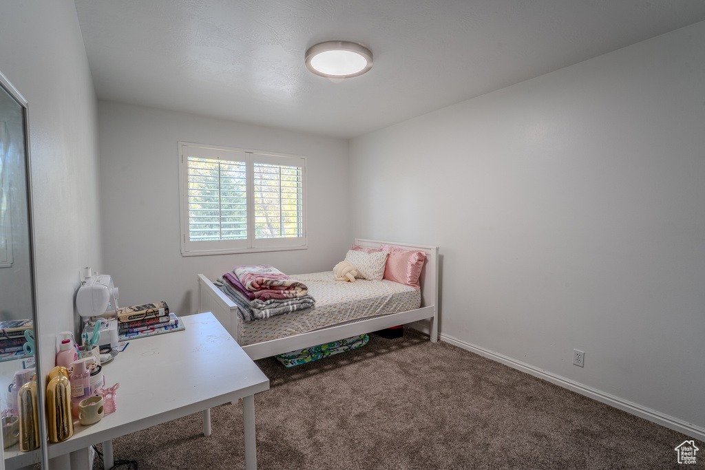 Bedroom with baseboards and carpet