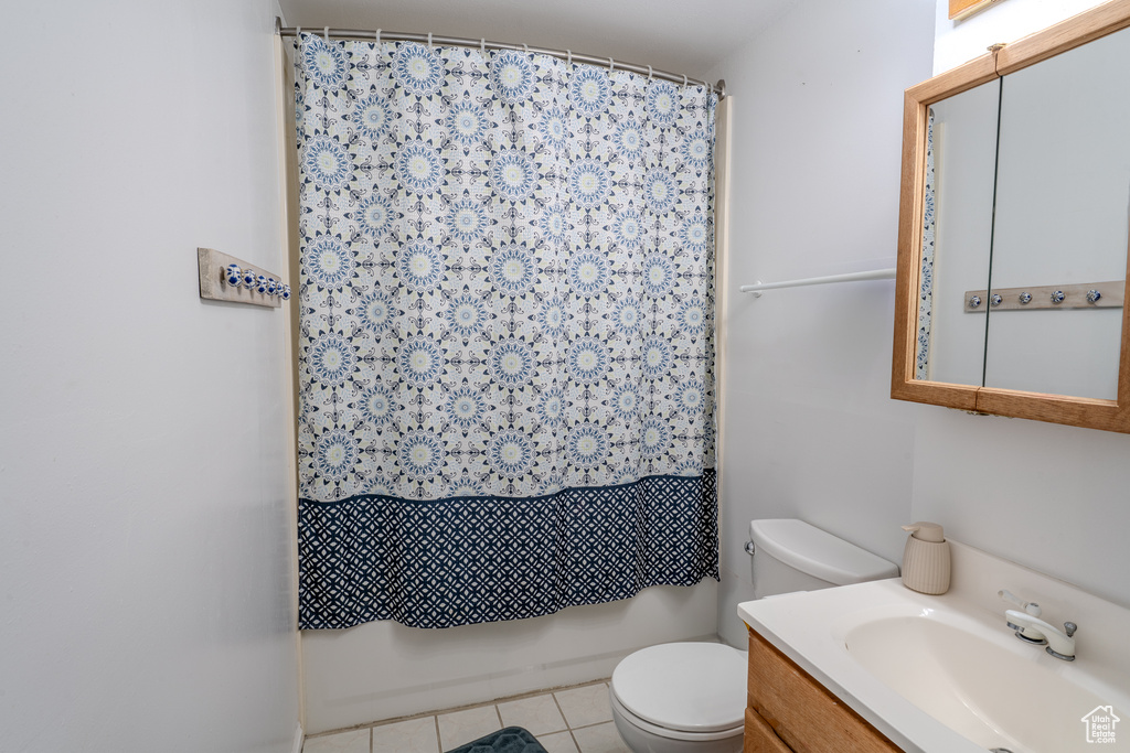Full bathroom featuring vanity, tile patterned floors, and toilet