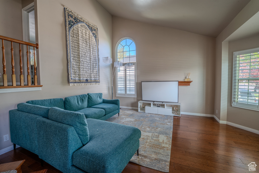 Living room featuring baseboards and hardwood / wood-style flooring