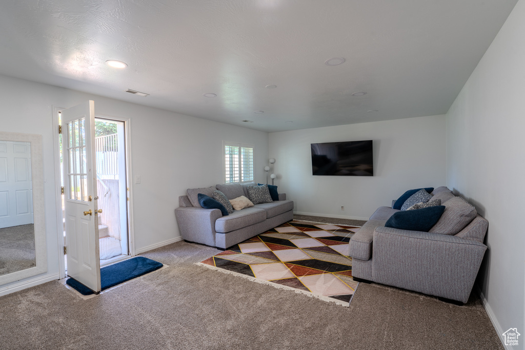 Carpeted living room with baseboards