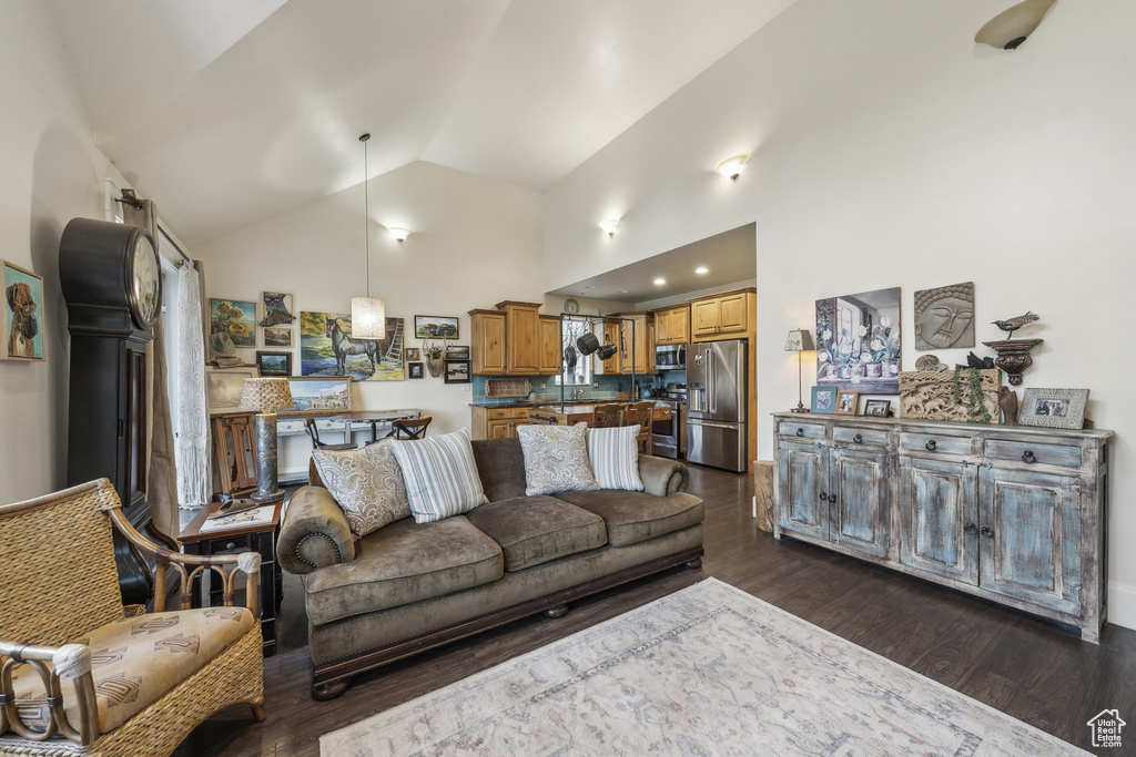 Living area with dark wood-style flooring and lofted ceiling