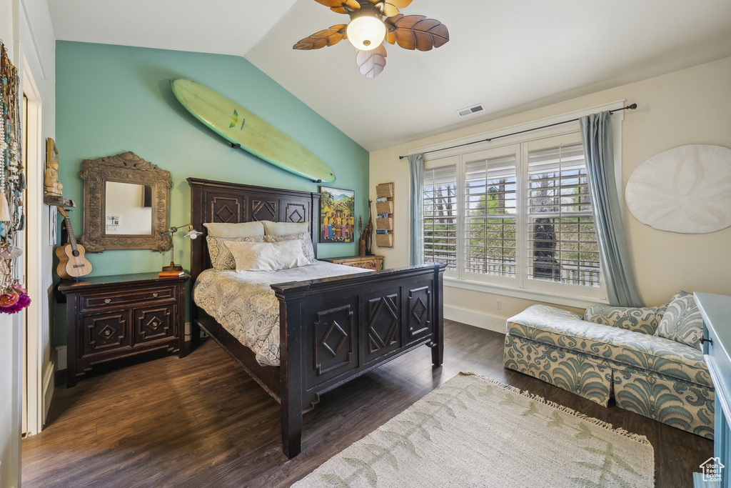 Bedroom with ceiling fan, baseboards, wood finished floors, lofted ceiling, and visible vents