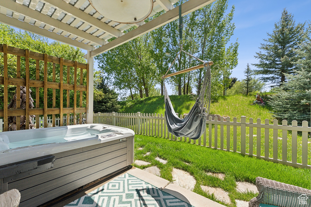 View of patio with a hot tub