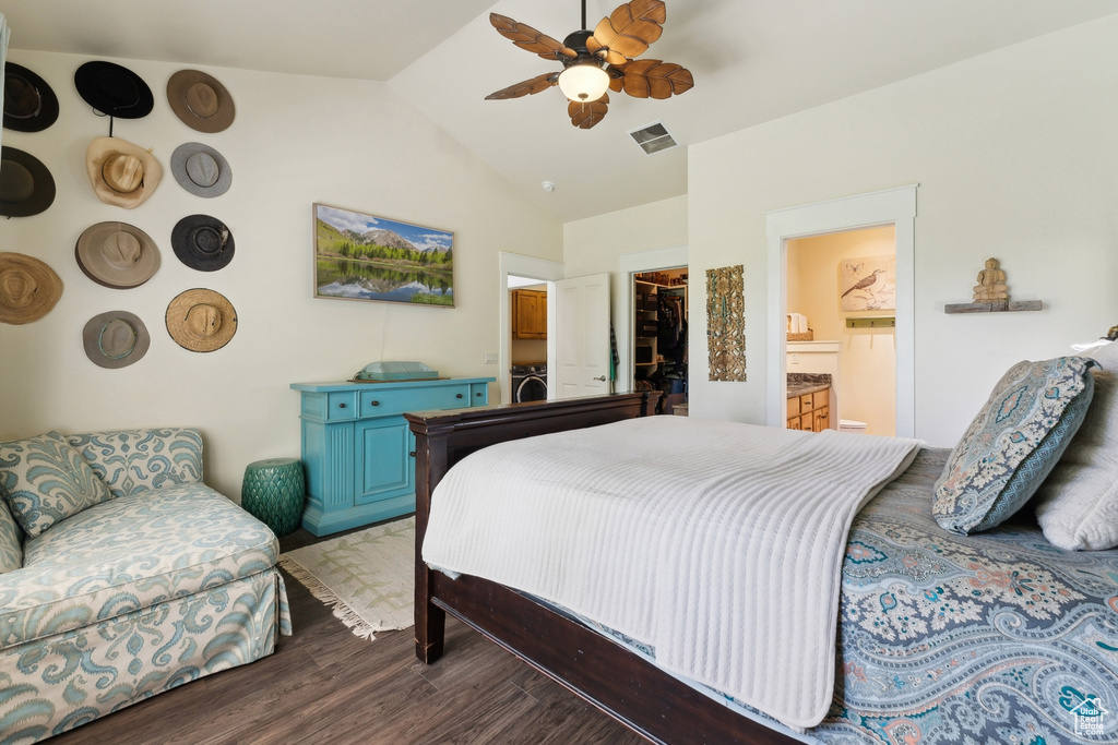 Bedroom with a walk in closet, vaulted ceiling, wood finished floors, a closet, and ensuite bathroom