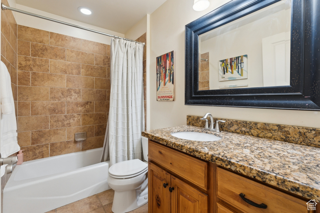 Bathroom featuring vanity, shower / tub combo, toilet, recessed lighting, and tile patterned flooring