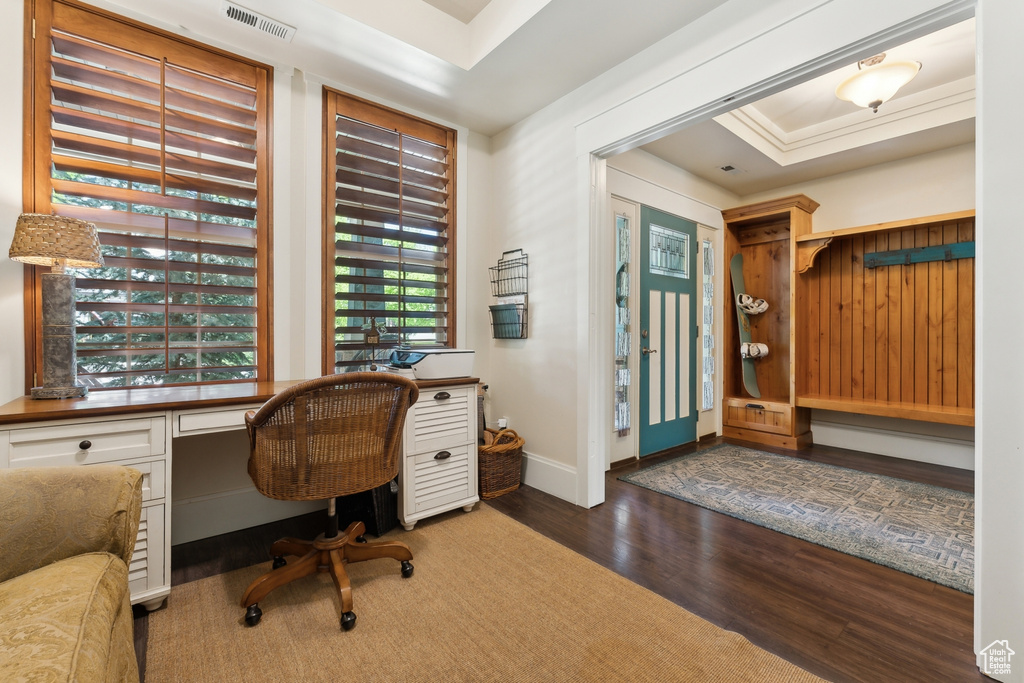Office space with wood finished floors and baseboards