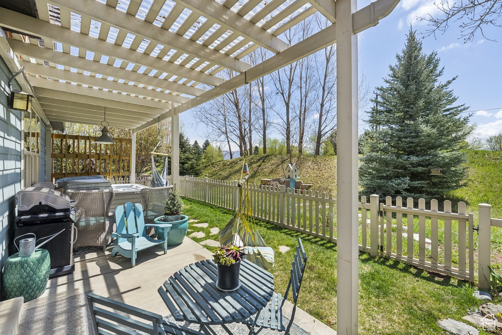 View of patio with area for grilling, a pergola, and fence private yard