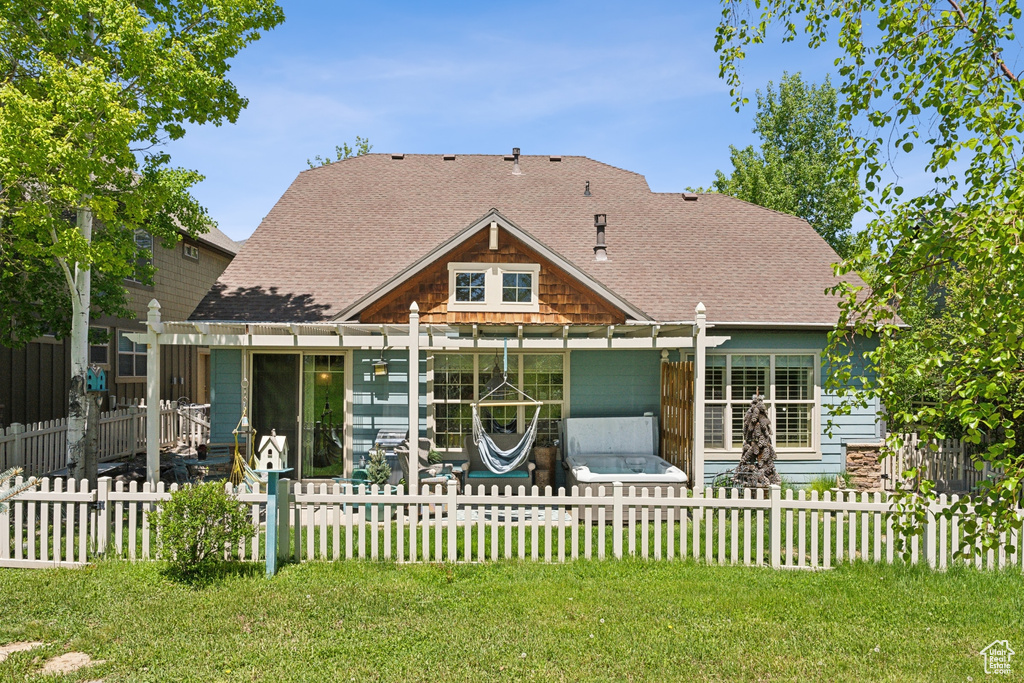 Back of property featuring a shingled roof, a pergola, and a patio