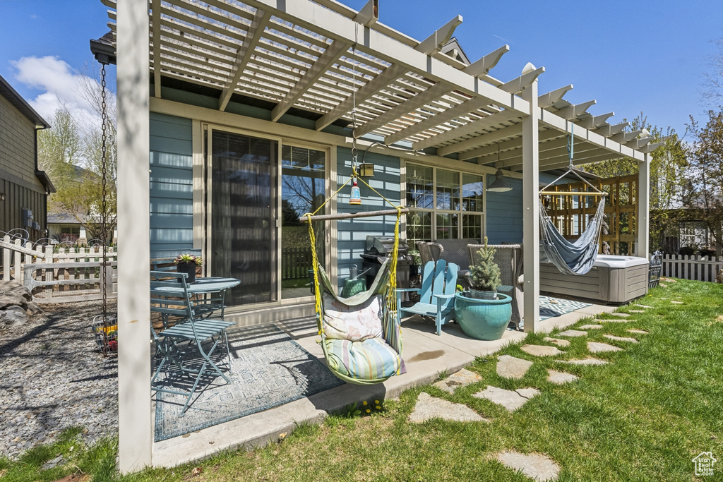 View of outdoor structure featuring fence and a pergola