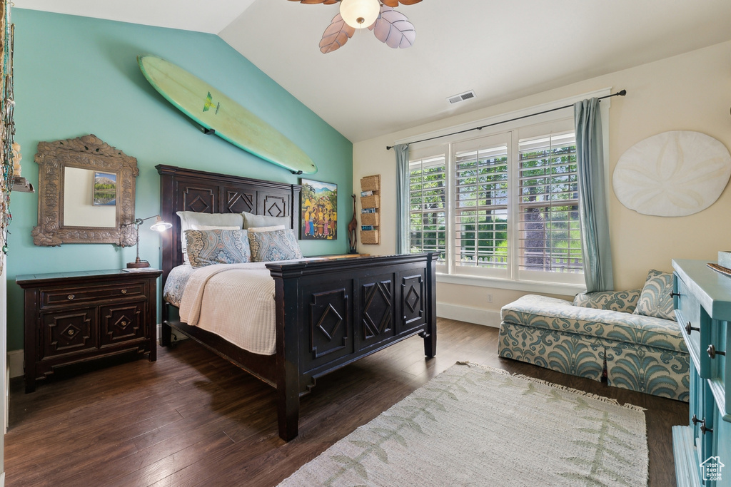 Bedroom featuring vaulted ceiling, wood finished floors, ceiling fan, and baseboards