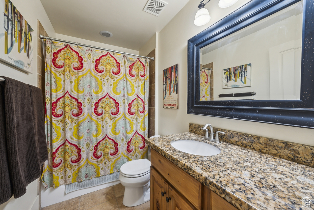 Bathroom featuring visible vents, tile patterned floors, toilet, and vanity
