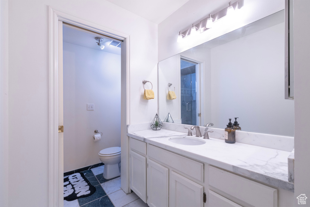 Bathroom featuring vanity and toilet