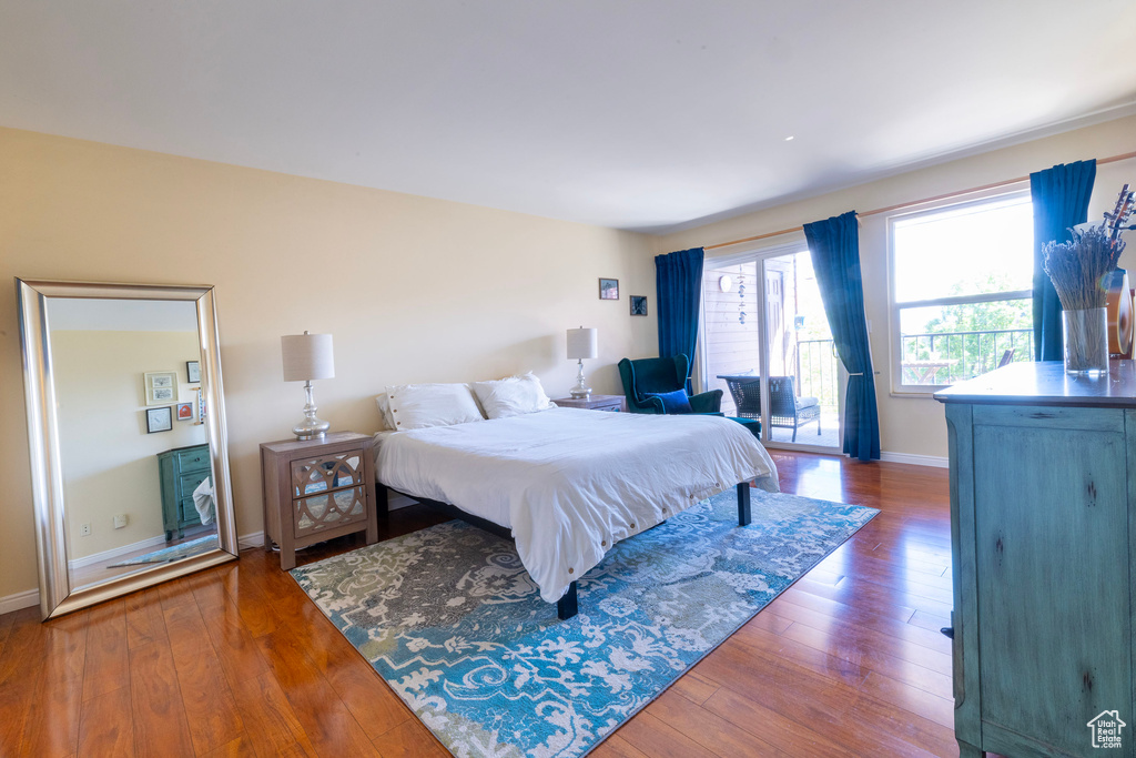 Bedroom featuring hardwood / wood-style floors and baseboards