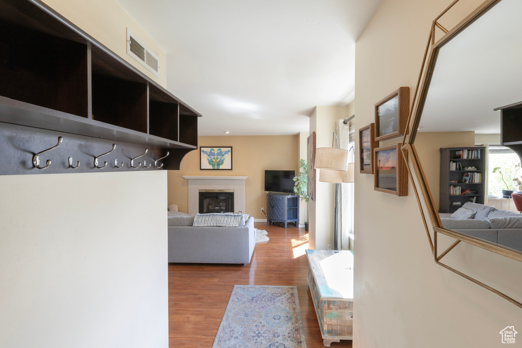 Hallway featuring visible vents and wood finished floors