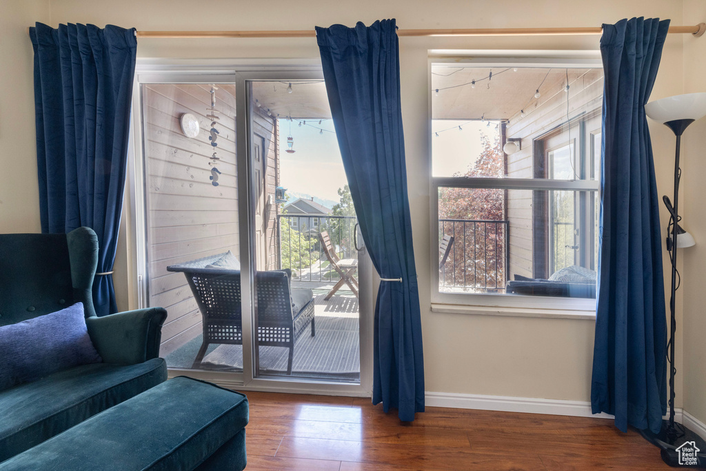 Entryway with baseboards and wood finished floors
