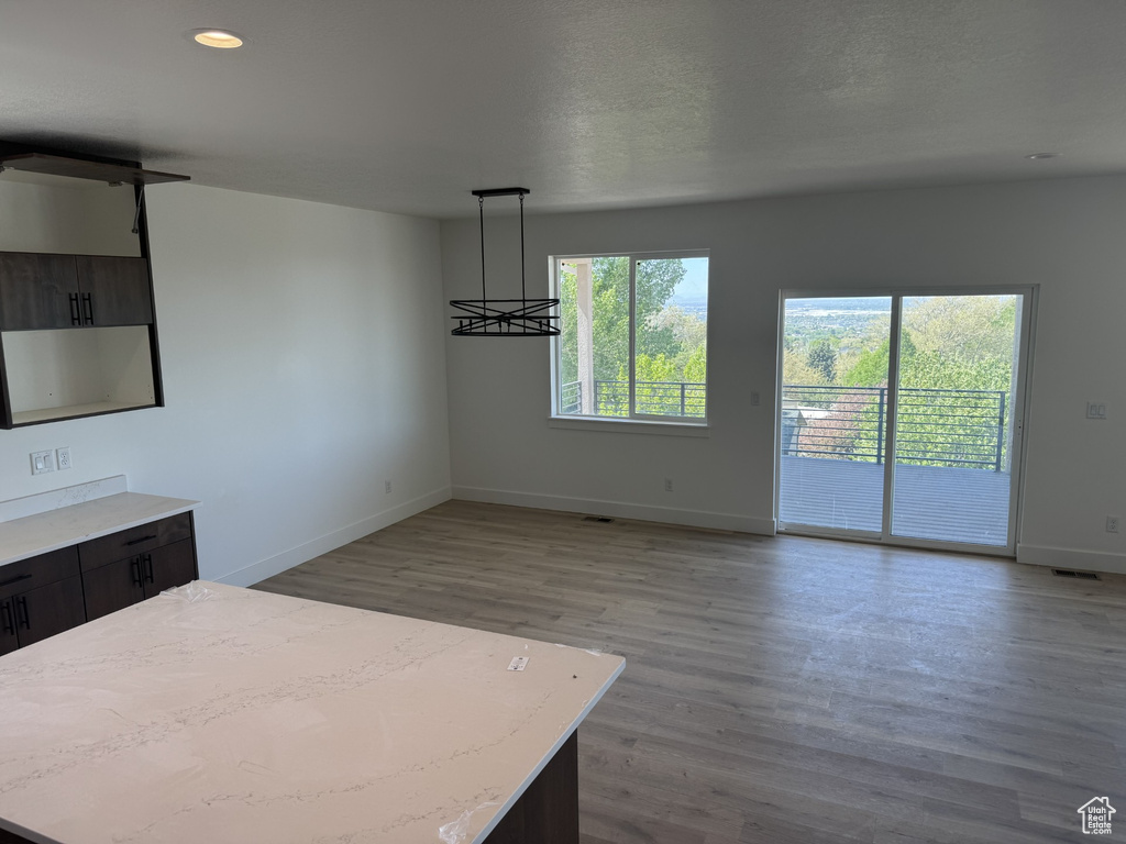 Interior space with baseboards, recessed lighting, wood finished floors, and visible vents