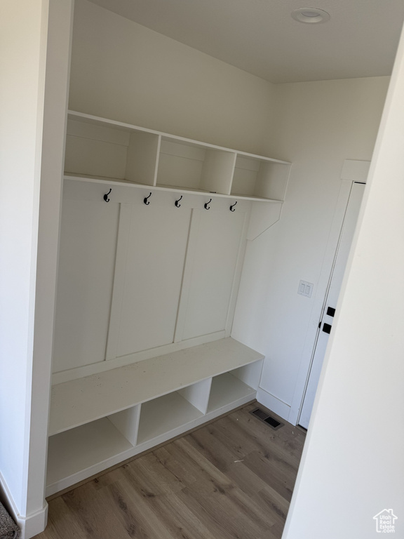 Mudroom featuring baseboards, light wood finished floors, and visible vents