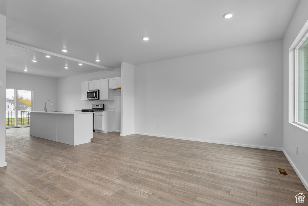 Kitchen with a sink, a wealth of natural light, stainless steel appliances, and visible vents