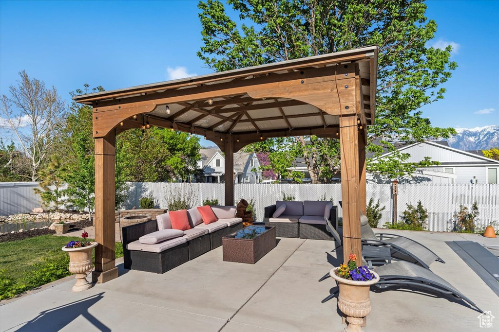 View of patio / terrace with a gazebo, an outdoor living space, and a fenced backyard