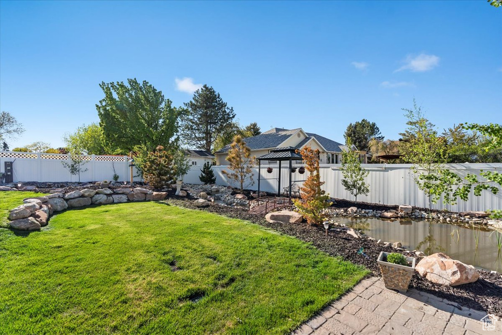 View of yard with a gazebo and a fenced backyard