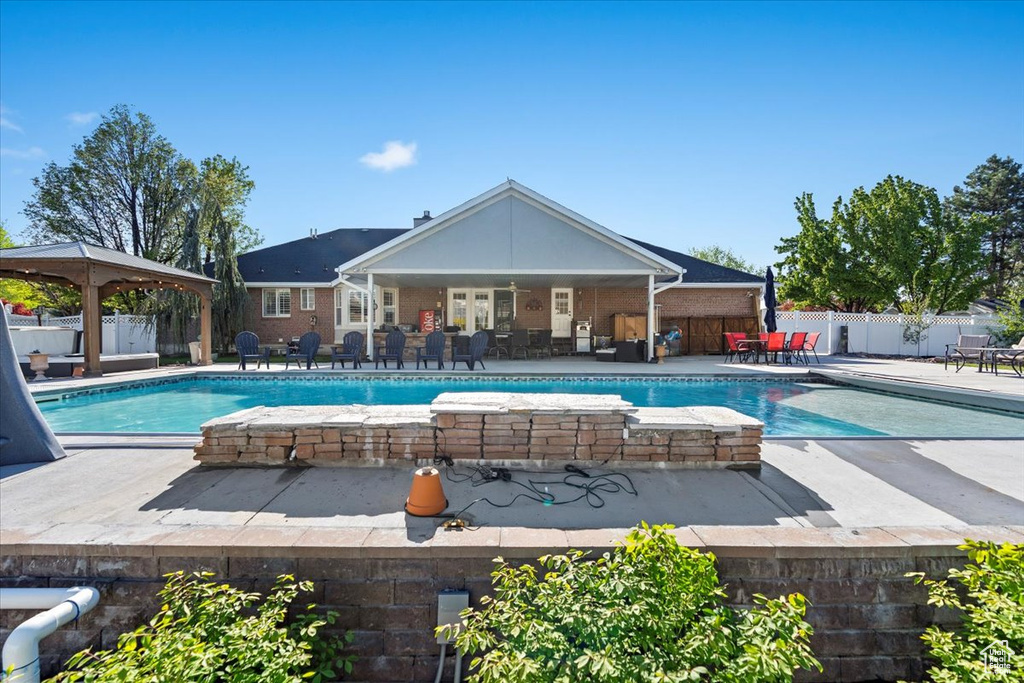 View of swimming pool featuring a fenced in pool, fence private yard, a gazebo, and a patio area