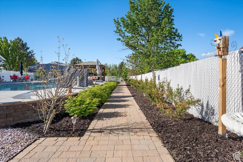 Surrounding community featuring a swimming pool, fence, and a patio