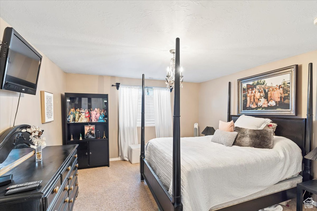Bedroom featuring baseboards and light colored carpet
