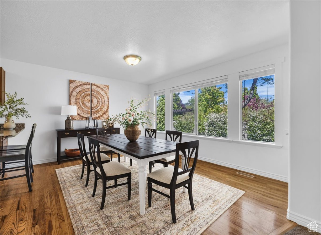 Dining space featuring baseboards and wood finished floors