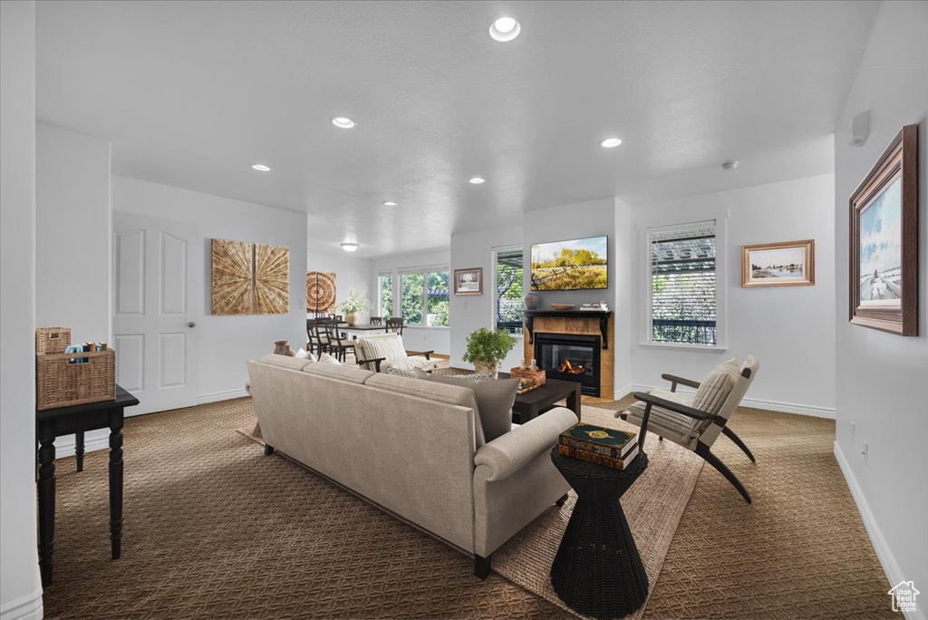 Carpeted living room with recessed lighting, a fireplace, and baseboards