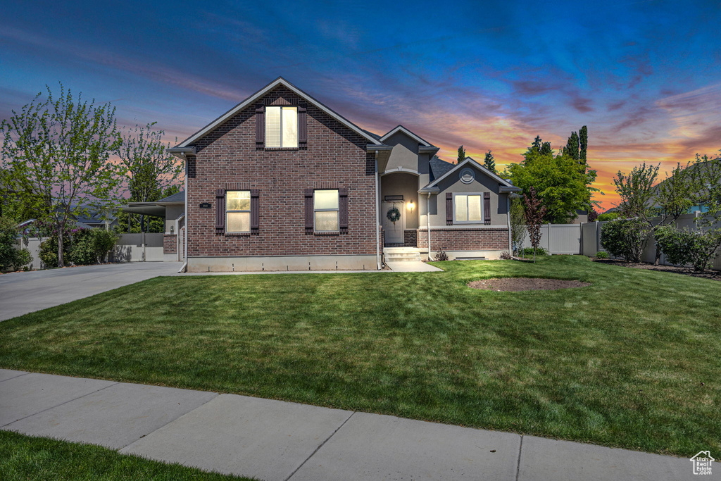 Traditional home featuring brick siding and concrete driveway