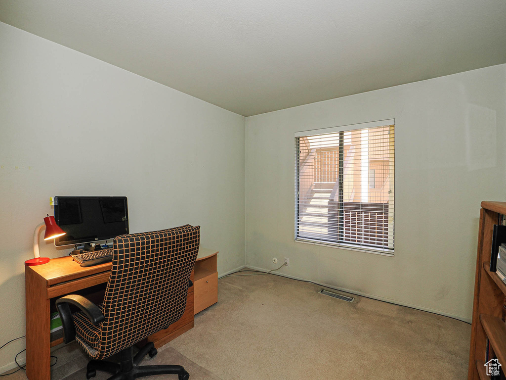 Office area featuring carpet floors and visible vents