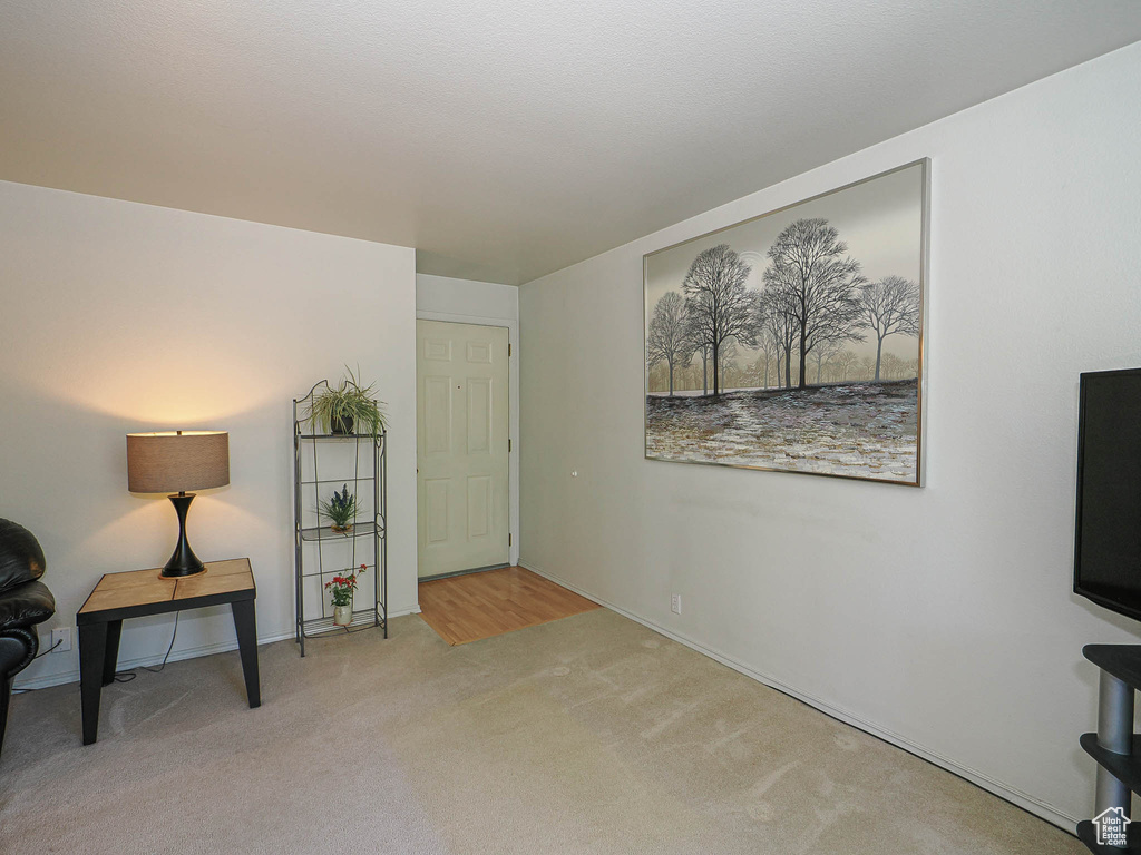 Living area with carpet flooring and baseboards