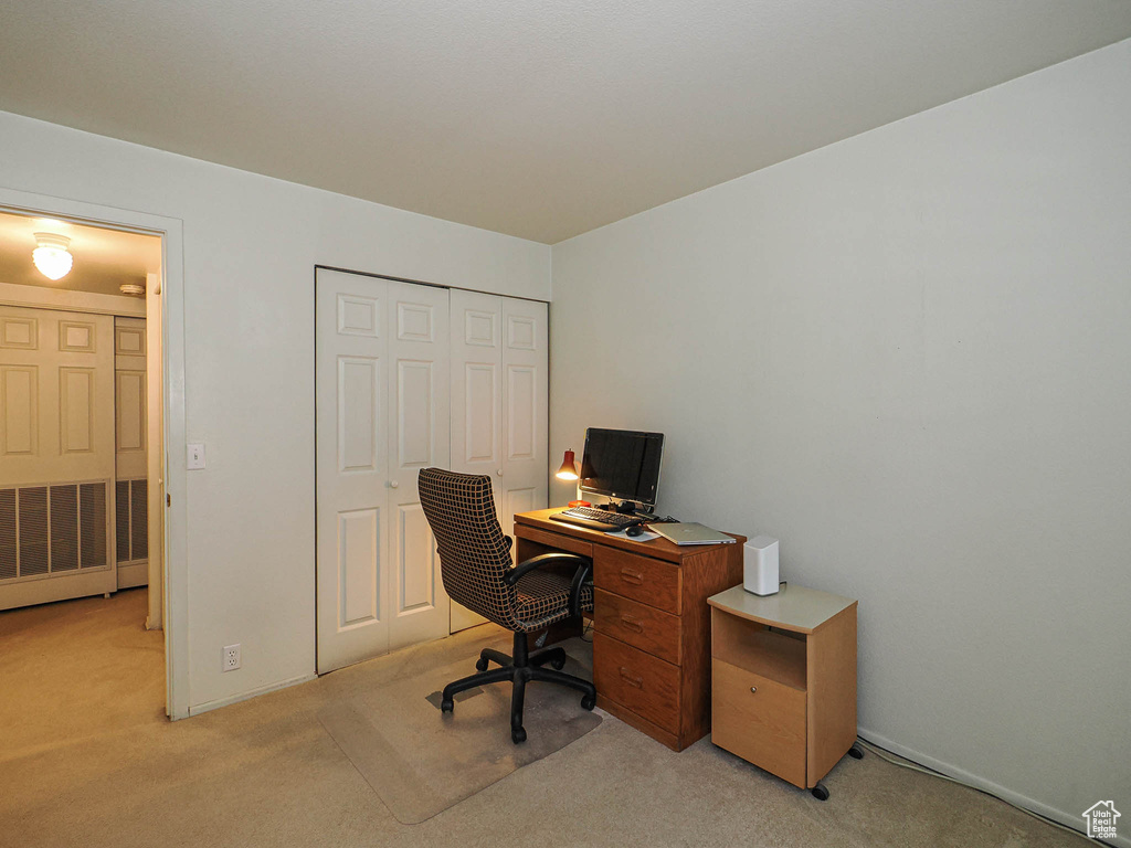 Home office featuring light colored carpet