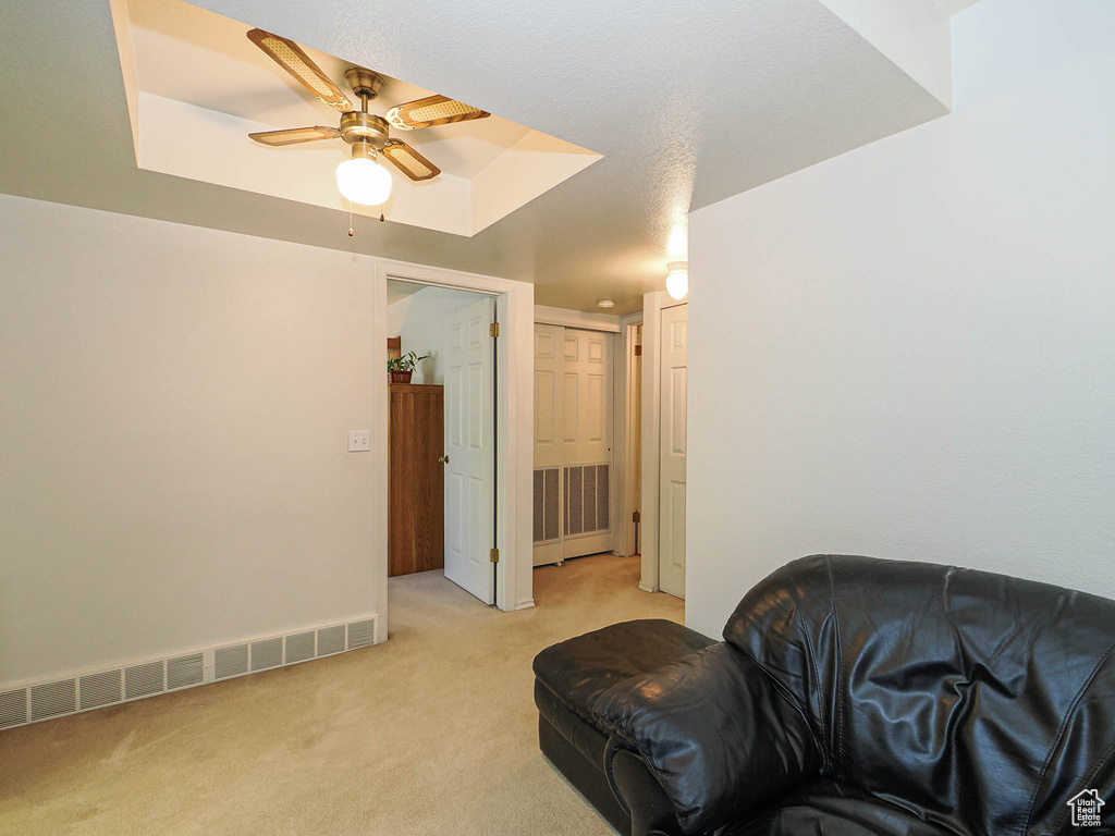 Living room with ceiling fan, light carpet, and visible vents