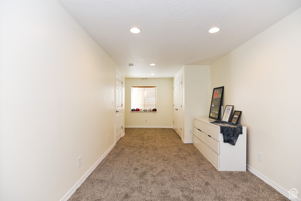 Hallway with recessed lighting, baseboards, and light carpet