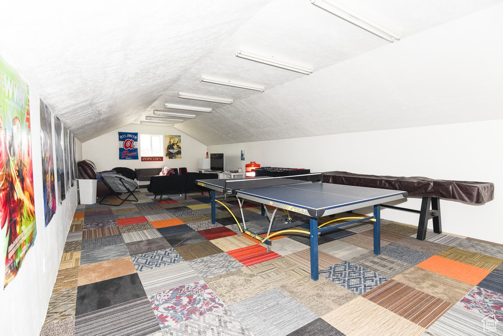 Playroom featuring carpet floors and vaulted ceiling
