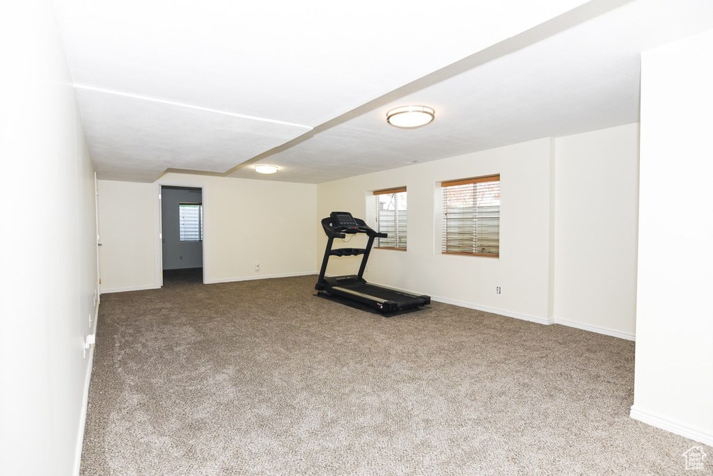 Exercise area featuring baseboards and carpet
