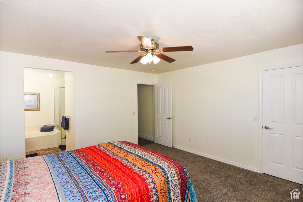 Bedroom featuring carpet floors, ceiling fan, ensuite bathroom, and baseboards