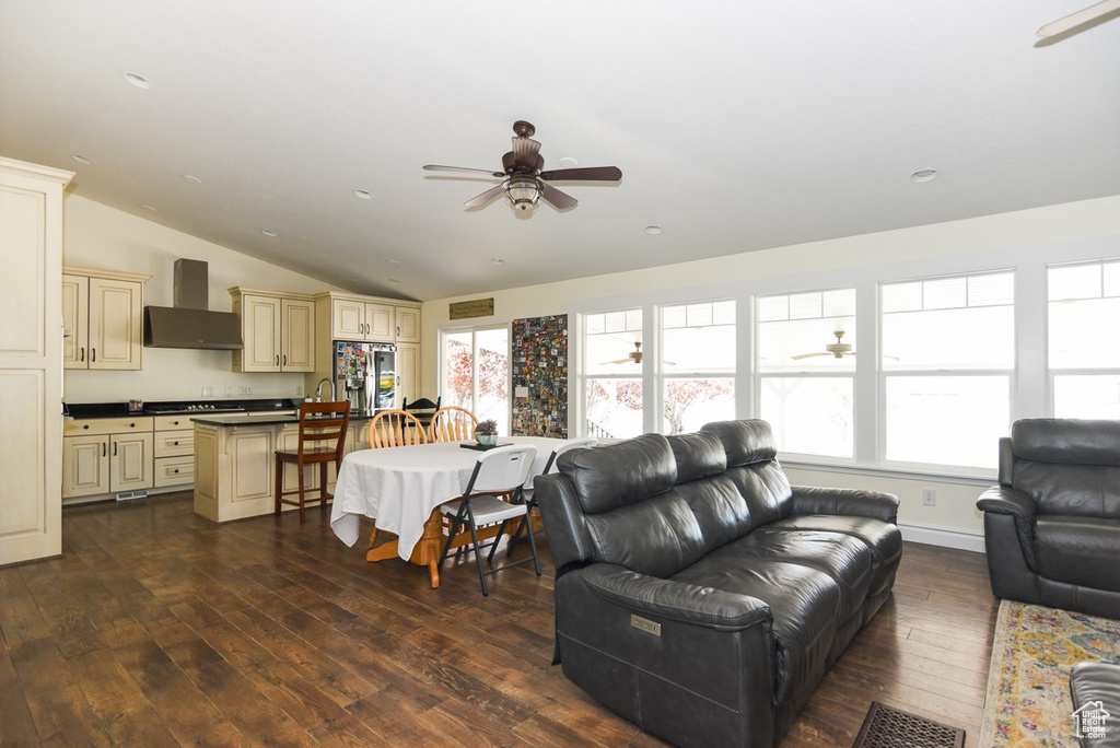 Living room featuring vaulted ceiling, a ceiling fan, recessed lighting, and dark wood-type flooring