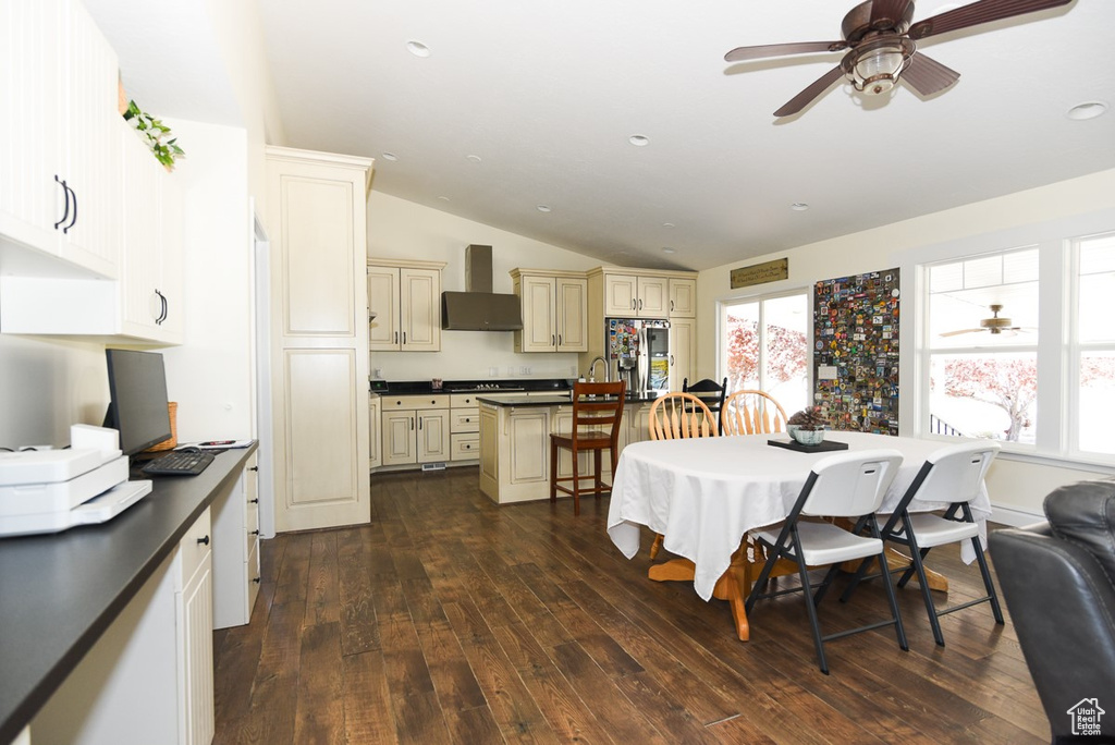 Dining area with a ceiling fan, vaulted ceiling, recessed lighting, and dark wood-type flooring