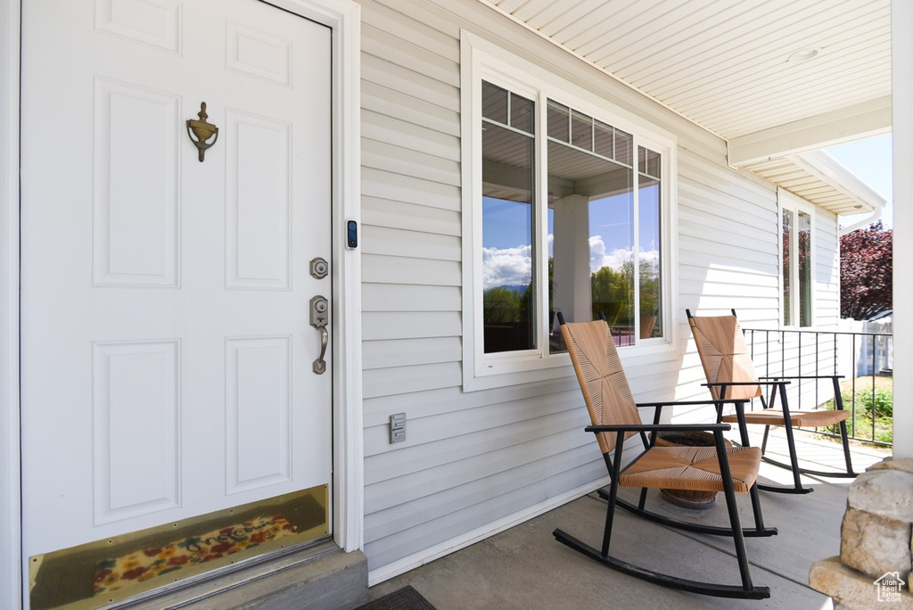 Doorway to property featuring a porch