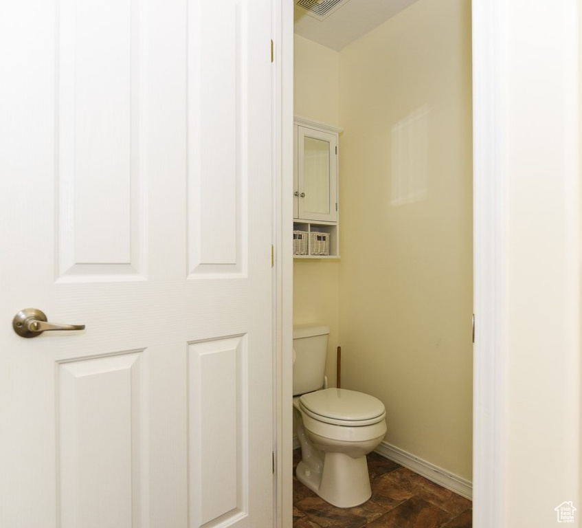 Bathroom with baseboards and toilet