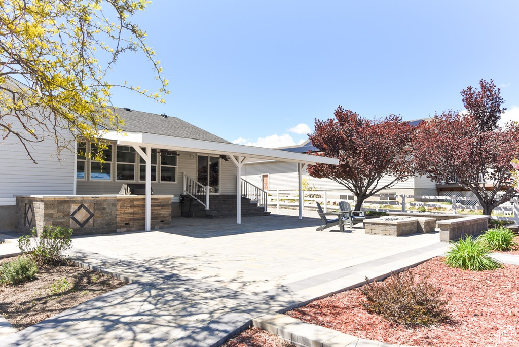 View of front of house with a patio, driveway, and a carport